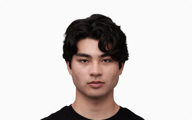 Front portrait of a young adult man with even skin and bright sclera as a youthfulness reference