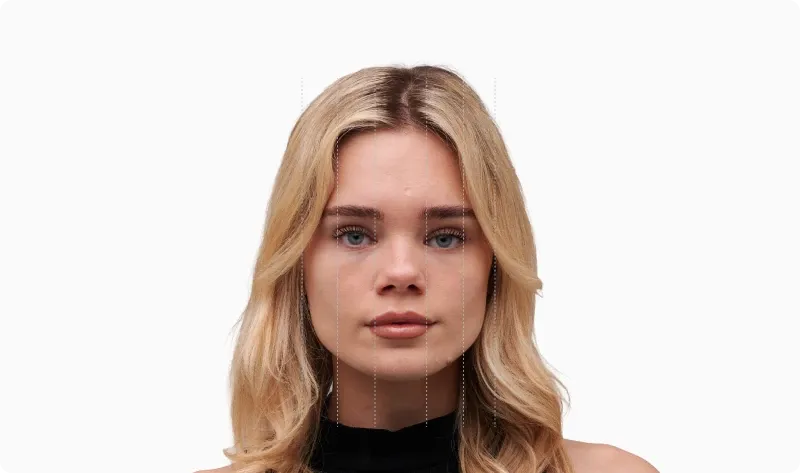 Front portrait of the same blonde woman with the face divided into vertical fifths by dotted lines