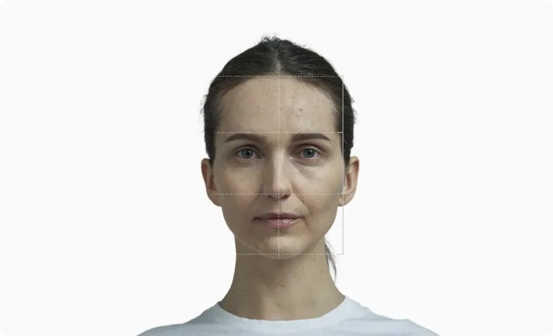 Front portrait of a woman with a facial thirds grid drawn across the face